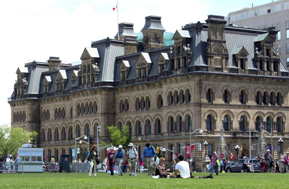 People gather on the lawn outside the Langevin Block building, renamed the Office of the Prime Minister and Privy Council, on June 21, 2017. The Trudeau Foundation held three meetings in the building between April 2016 and March 2017. (The Canadian Press/Adrian Wyld)