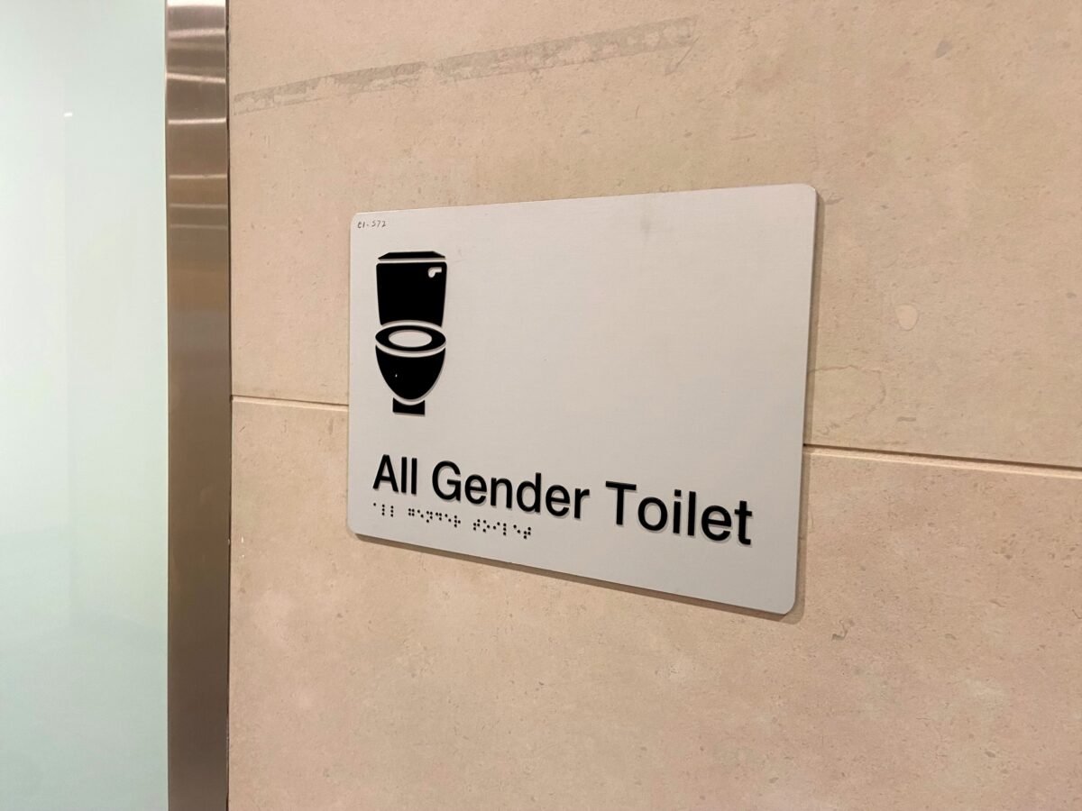 Signage for an 'all gender' bathroom at Sydney's International Airport in Australia on Dec. 11, 2022. (Daniel Teng/The Epoch Times)