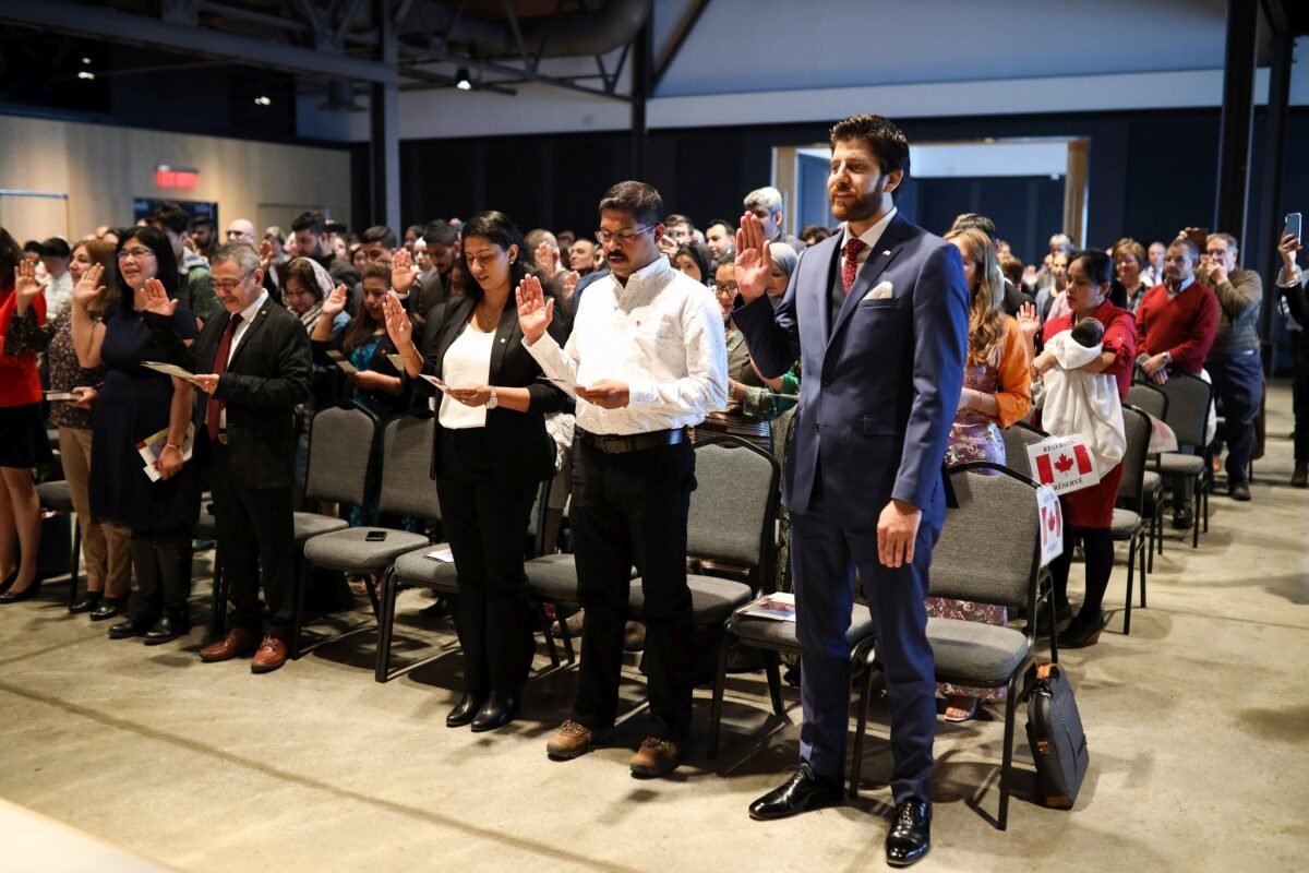 New Canadians take the Oath of Citizenship in a ceremony at the Canadian Museum of Immigration at Pier 21 in Halifax on Jan. 15, 2020. (The Canadian Press/Riley Smith)