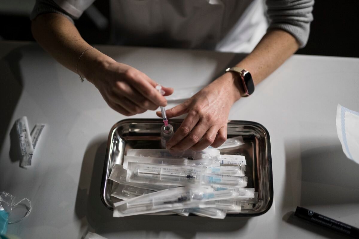 Nurse Coralie Ferron prepares doses of the Moderna COVID-19 vaccine at a vaccination center in Le Cannet, southern France, on Jan. 21, 2021. (Daniel Cole/ AP Photo, File)