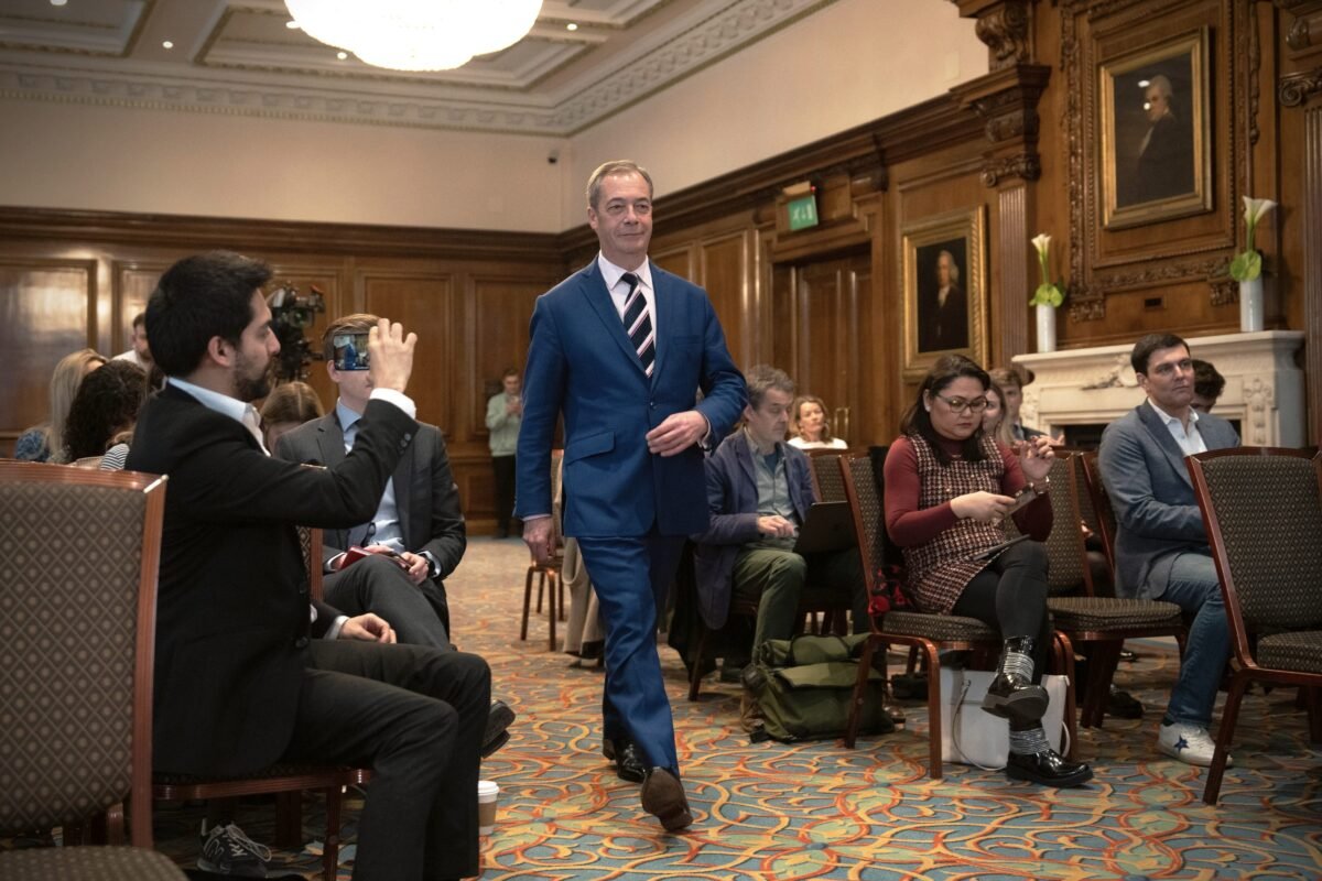 Reform UK honorary president Nigel Farage walks to the stage during a party press conference in London on March 20, 2023. (Carl Court/Getty Images)