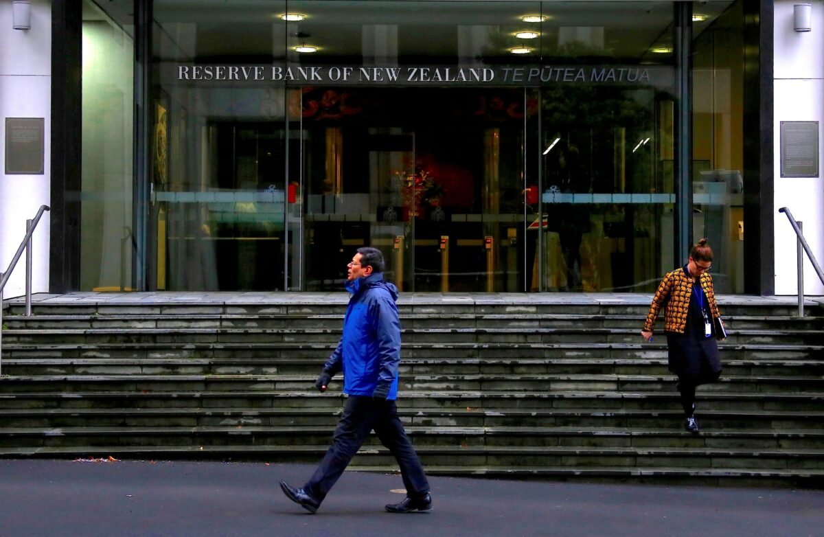 Pedestrians walk near the main entrance to the Reserve Bank of New Zealand located in central Wellington, New Zealand, on July 3, 2017. (David Gray/Reuters)