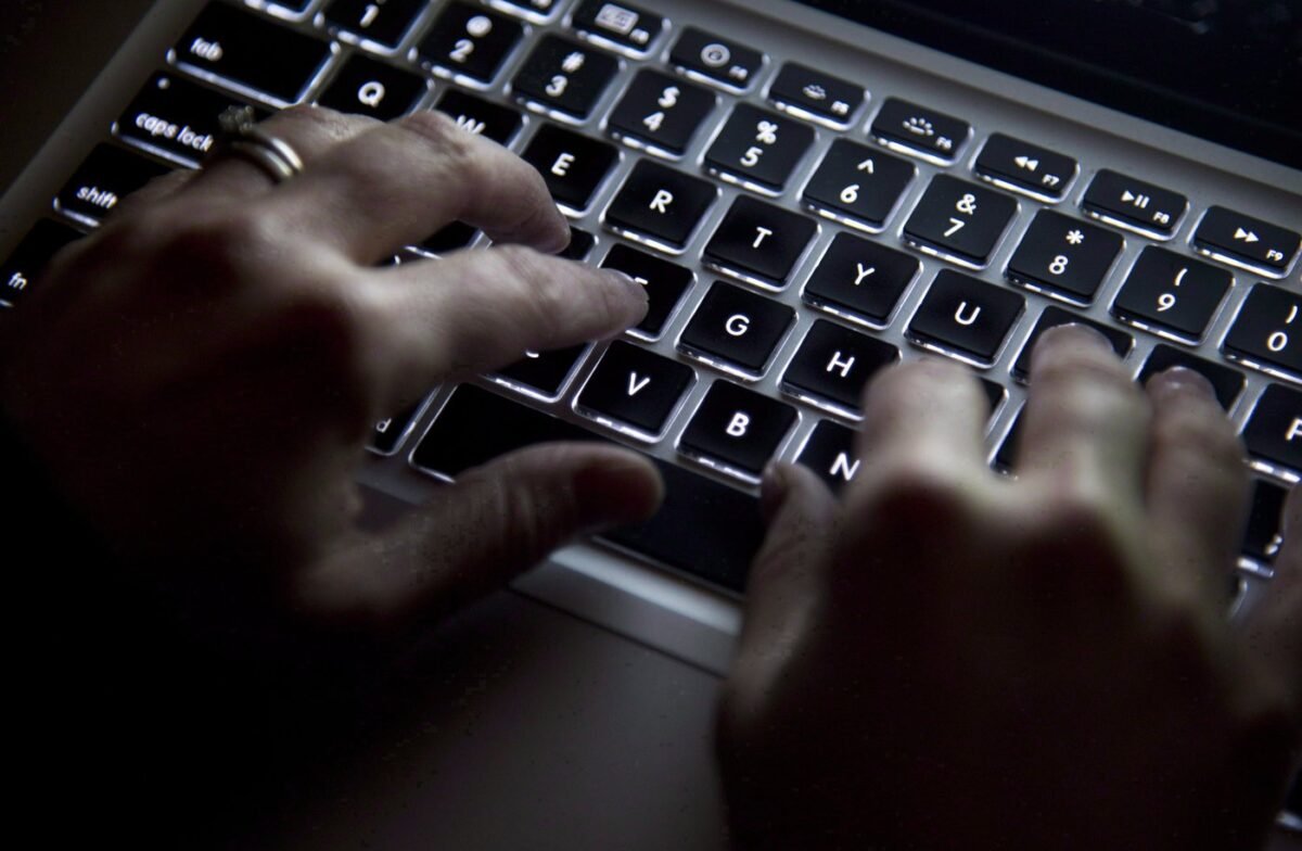 A woman uses her computer keyboard in North Vancouver, British Columbia, on Dec. 19, 2012. (Jonathan Hayward/The Canadian Press)
