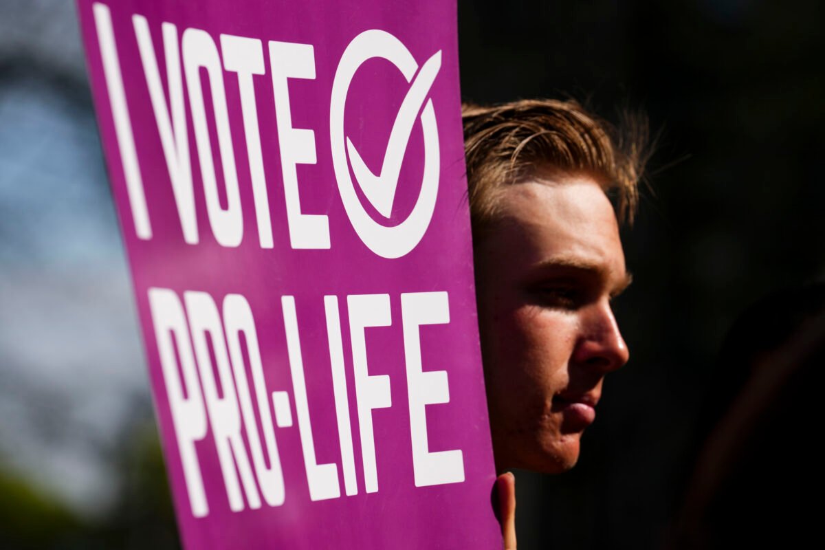 A participant holds a pro-life sign as the Campaign Life Coalition holds a press conference on the front lawn of the Supreme Court of Canada in Ottawa on May 11, 2022., a day before the March For Life. (Sean Kilpatrick/The Canadian Press)