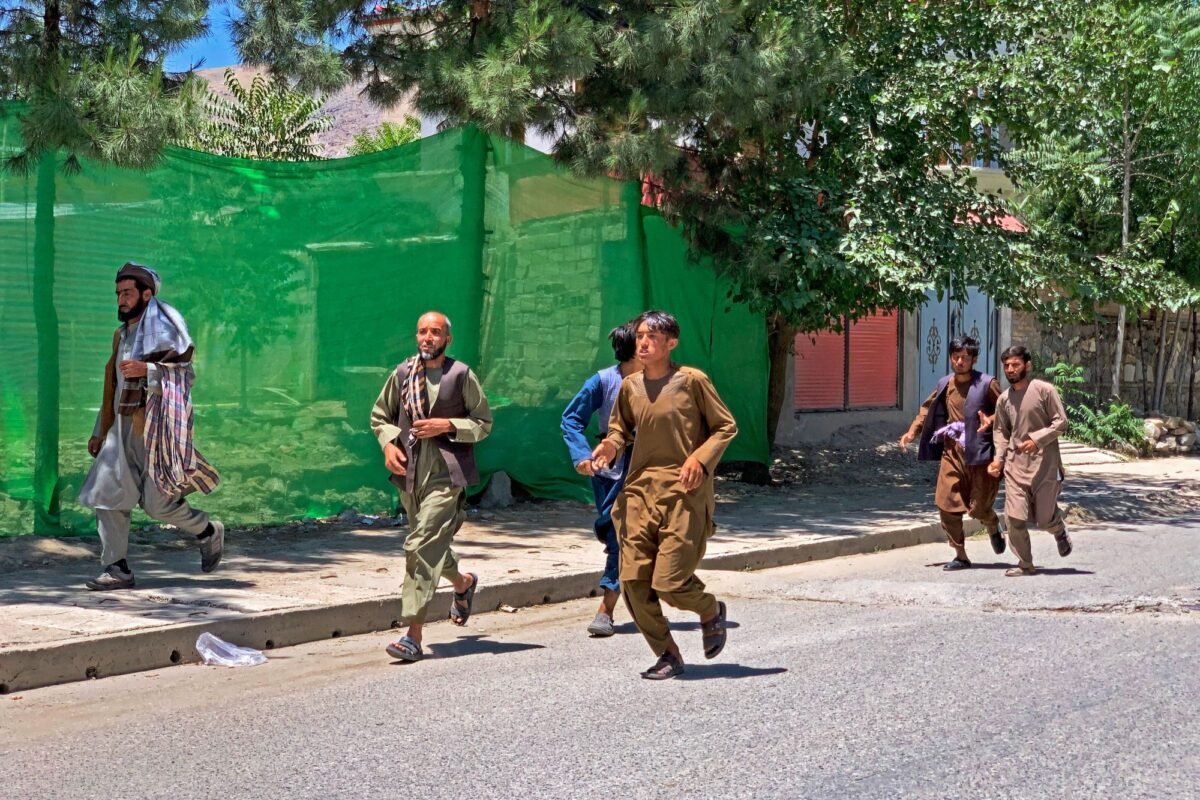 People run away after a bomb explosion during Fatiha prayers at the Nabawi mosque in the Hesa-e-Awal area of Fayzabad district, Badakhshan Province on June 8, 2023. (Omer Abrar/AFP via Getty Images)