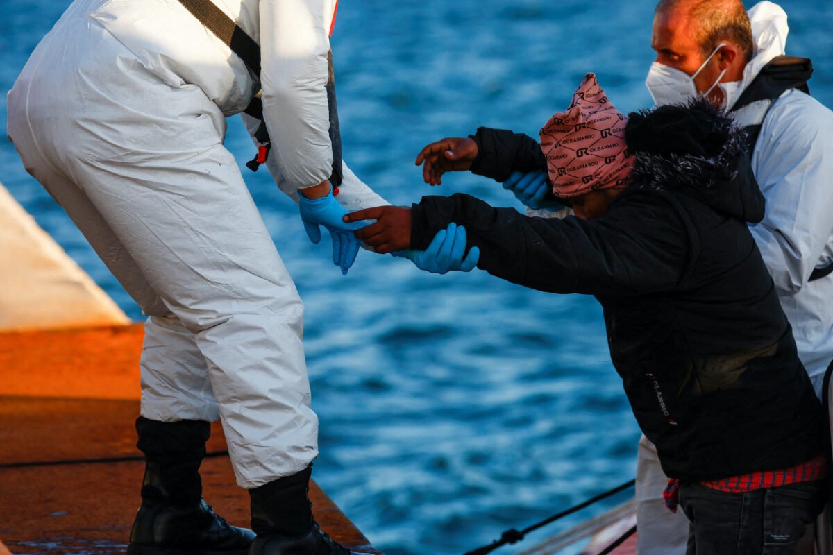 An illegal immigrant rescued by a merchant vessel disembarks from a Malta Armed Forces patrol boat outside Marsaxlokk, Malta, on April 17, 2023. (Darrin Zammit Lupi/Reuters)