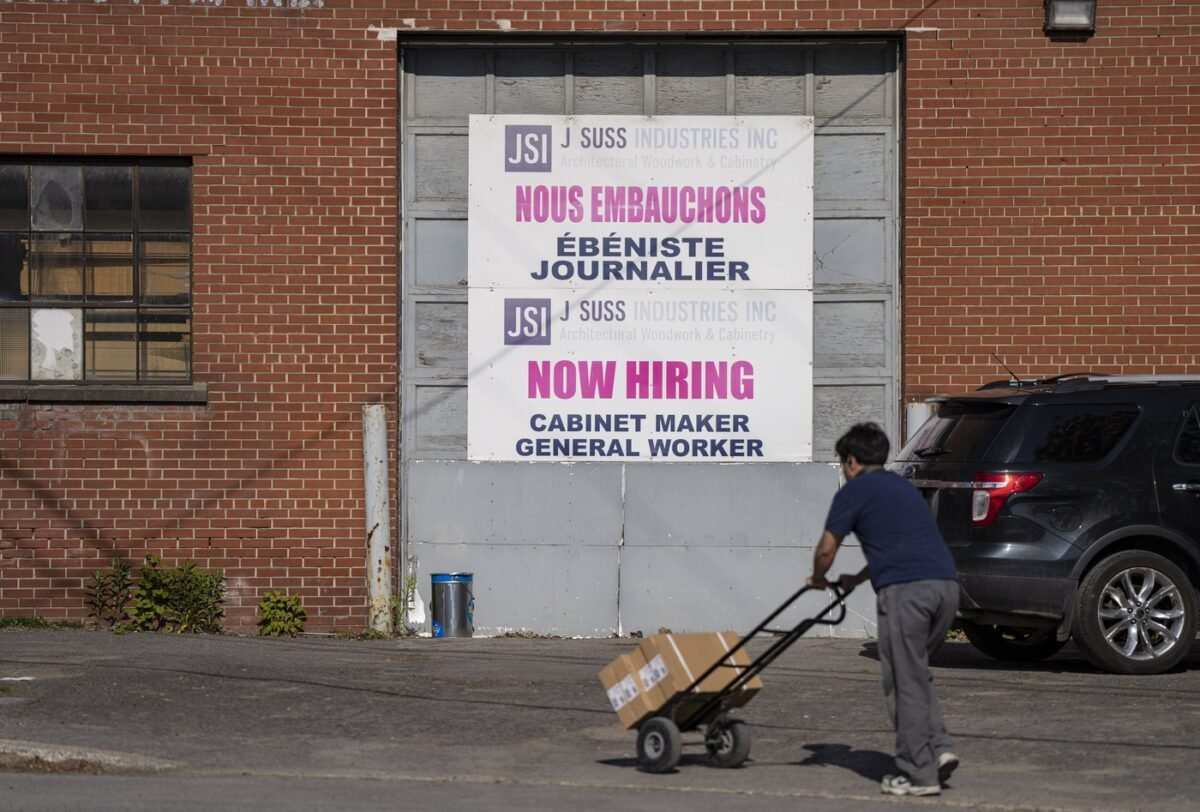 A "Now Hiring," sign is displayed on a business in Montreal on May 30, 2023. (The Canadian Press/Christinne Muschi)