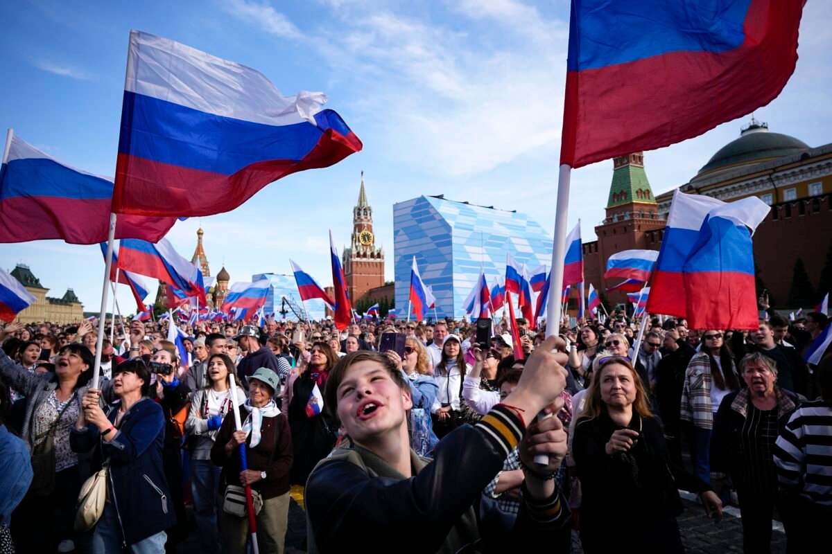Thousands of people wave Russian national flags as they gather on Red Square to watch a concert dedicated to the Day of Russia in Moscow, Russia on June 11, 2023. (Alexander Zemlianichenko/AP Photo)