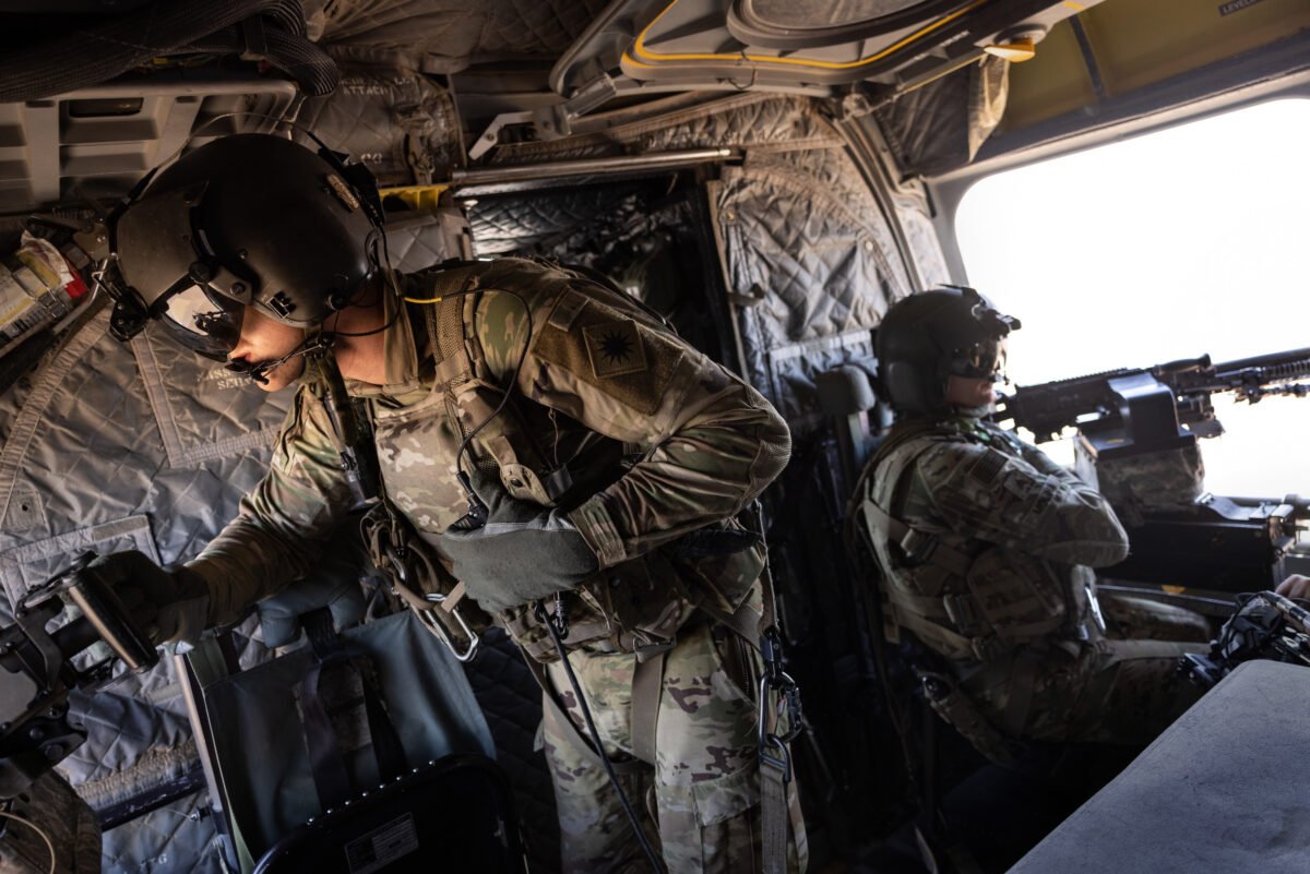 U.S. Army CH-47 Chinook helicopter gunners scan the desert while transporting troops over northeastern Syria on May 26, 2021. (John Moore/Getty Images)
