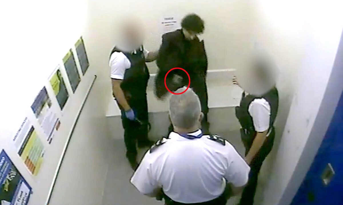 A screen grab taken from CCTV footage of Louis De Zoysa (centre, top) who is holding a gun (circled in red), seconds before Sergeant Matt Ratana (centre) was shot dead at Croydon custody centre in Croydon, London on Sep. 25, 2020. (Metropolitan Police)
