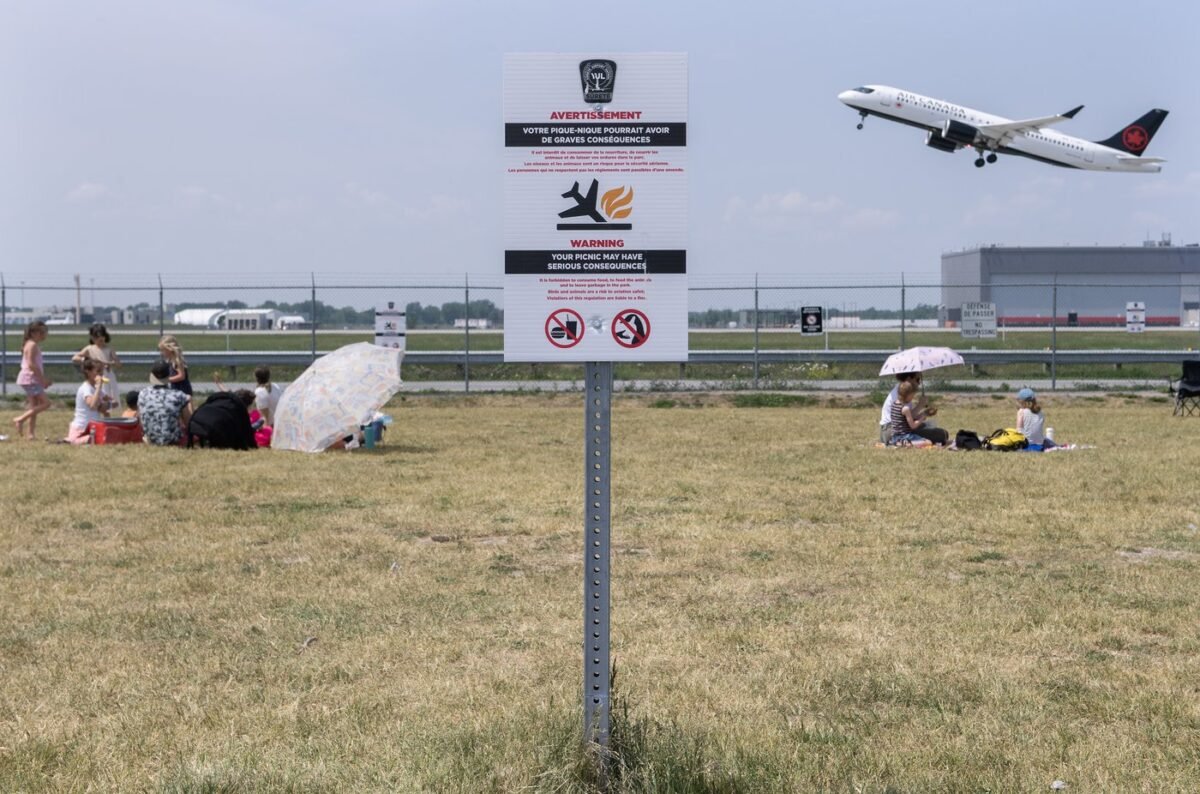 A sign warning people that the consumption of food is prohibited is shown at Jacques de Lesseps plane spotting park next to Trudeau Airport in Montreal, on June 11, 2023. (The Canadian Press/Graham Hughes)