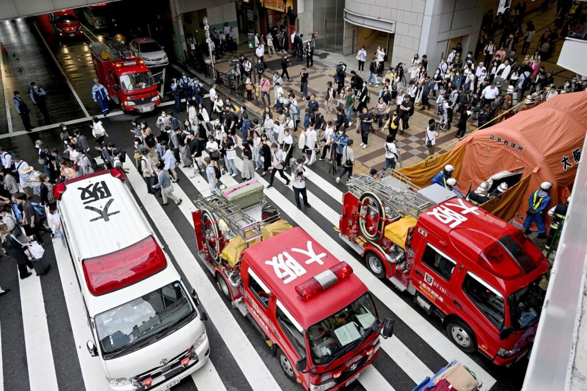An ambulance and fire trucks park near the scene of a spray attack in Osaka, western Japan, on June 14, 2023. (Kyodo News via AP)