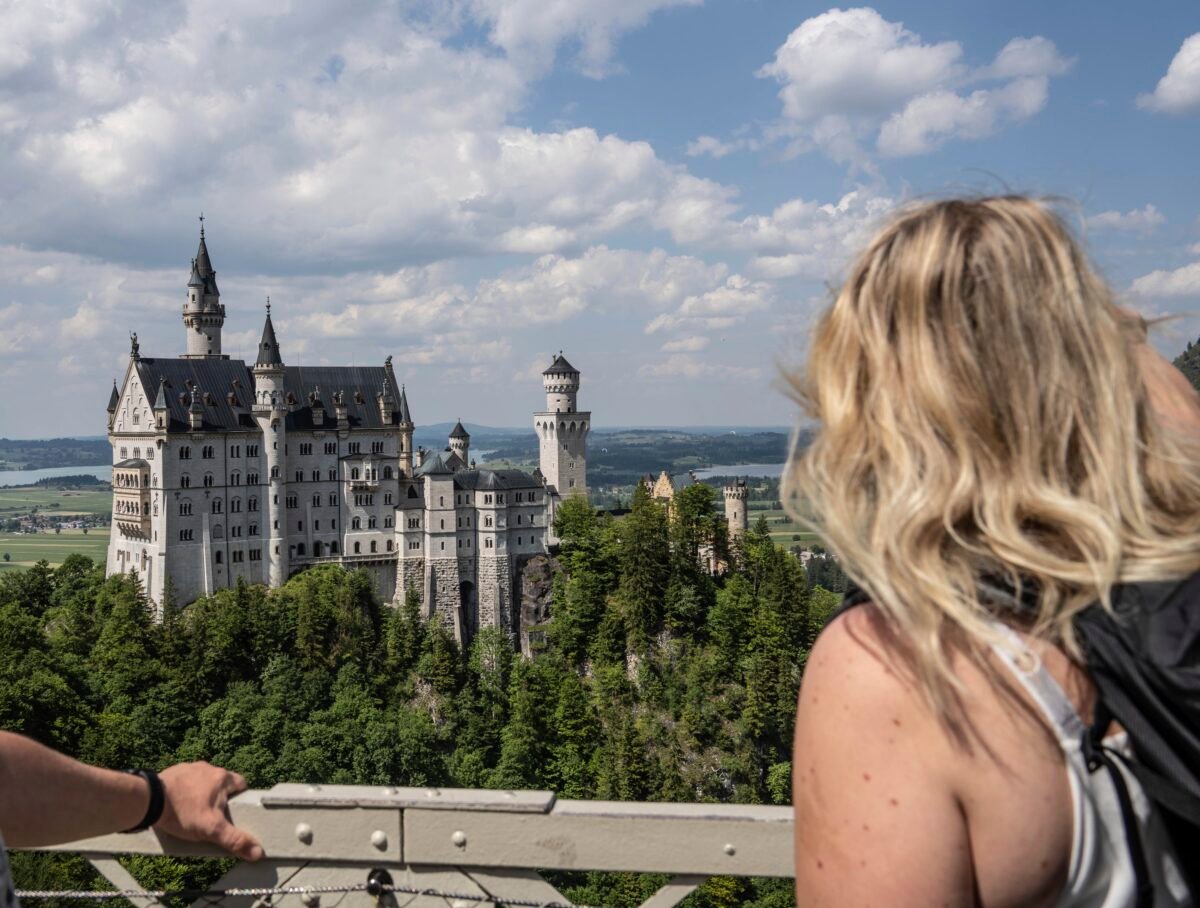 People watch the Neuschwanstein castle in Schwangau, Germany, on June 15, 2023. (Frank Rumpenhorst/dpa via AP)