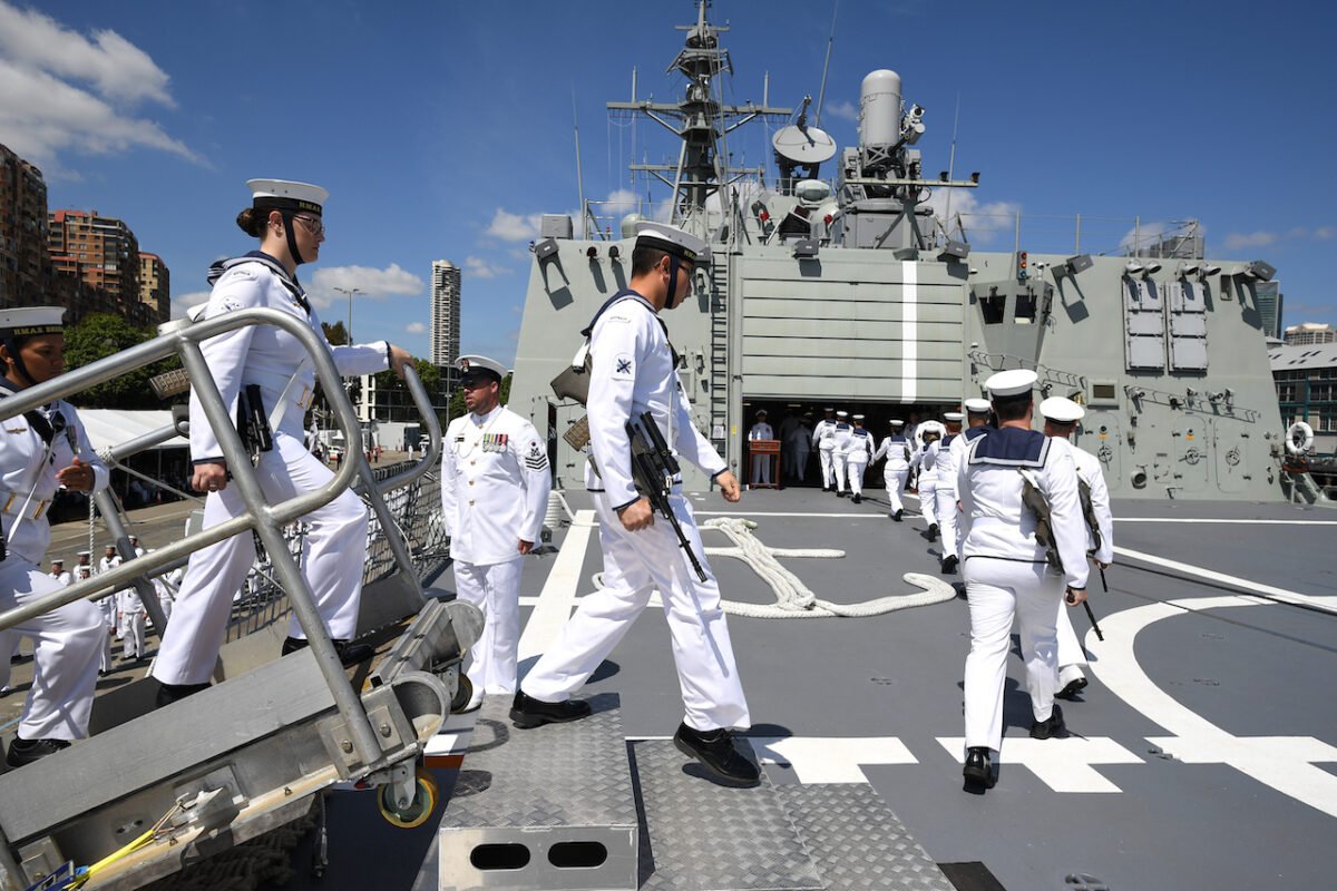 Navy personnel board HMAS Brisbane during a commissioning ceremony in Sydney, Oct. 27, 2018. (AAP Image/Joel Carrett)