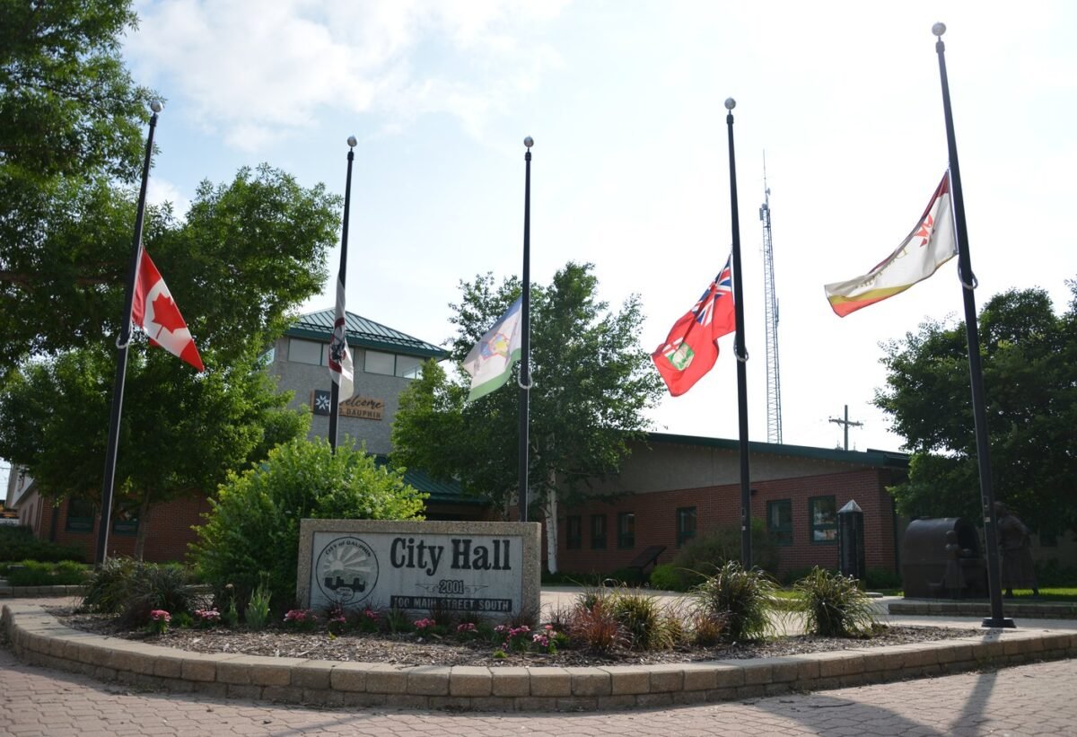 Flags outside Dauphin city hall fly at half mast on June 16, 2023. (The Canadian Press/Jeremy Simes)