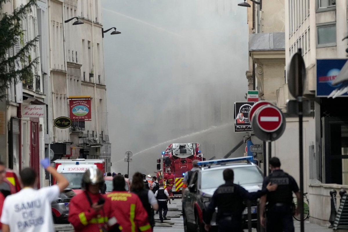 Firemen use a water canon as they fight a blaze in Paris, on June 21, 2023. (AP Photo/Christophe Ena)