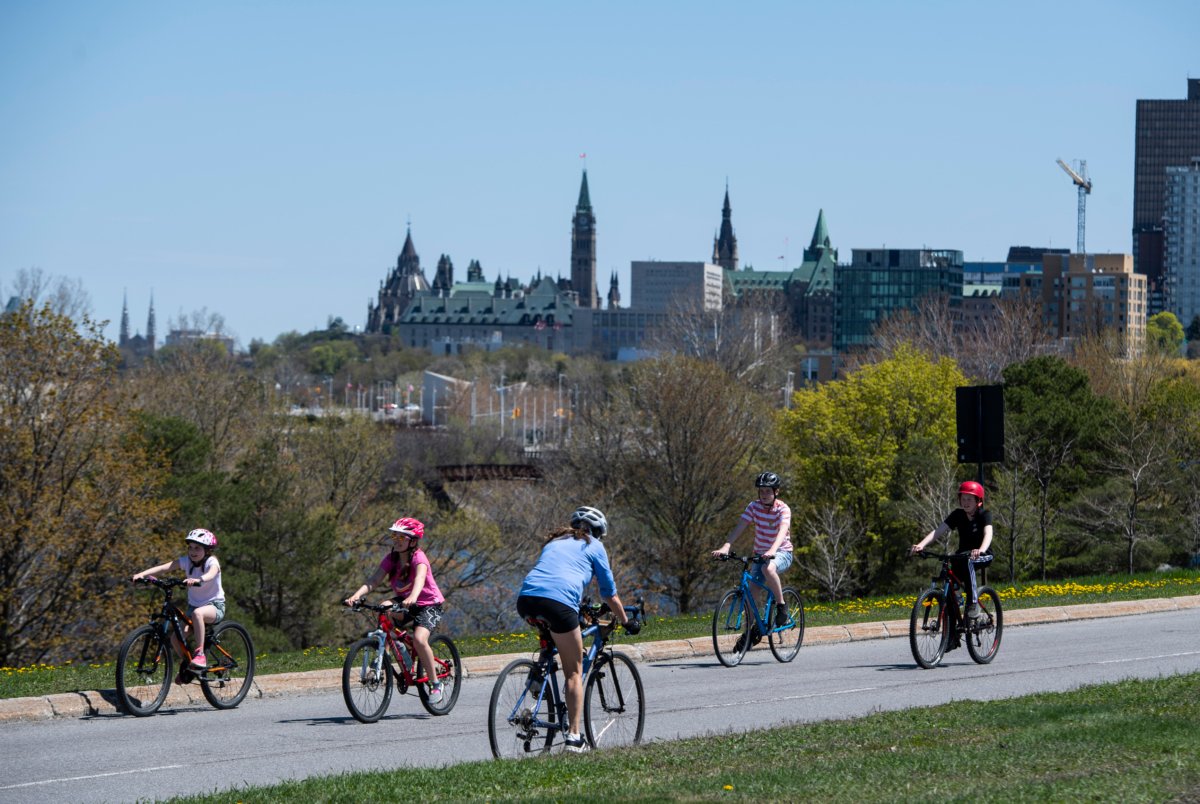 People ride their bikes on the westbound lane of the Sir John A. Macdonald Parkway in Ottawa on May 18, 2020. The National Capital Commission has approved a new Algonquin Nation name for the parkway, Kichi Zībī Mīkan, on June 22, 2023. (Justin Tang/The Canadian Press)