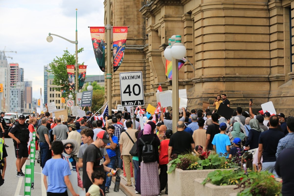 A large crowd of protesters in Ottawa gather outside Prime Minister Justin Trudeau's Ottawa office on June 24, 2023, to protest teachings about gender ideology in schools. (Jonathan Ren/The Epoch Times)