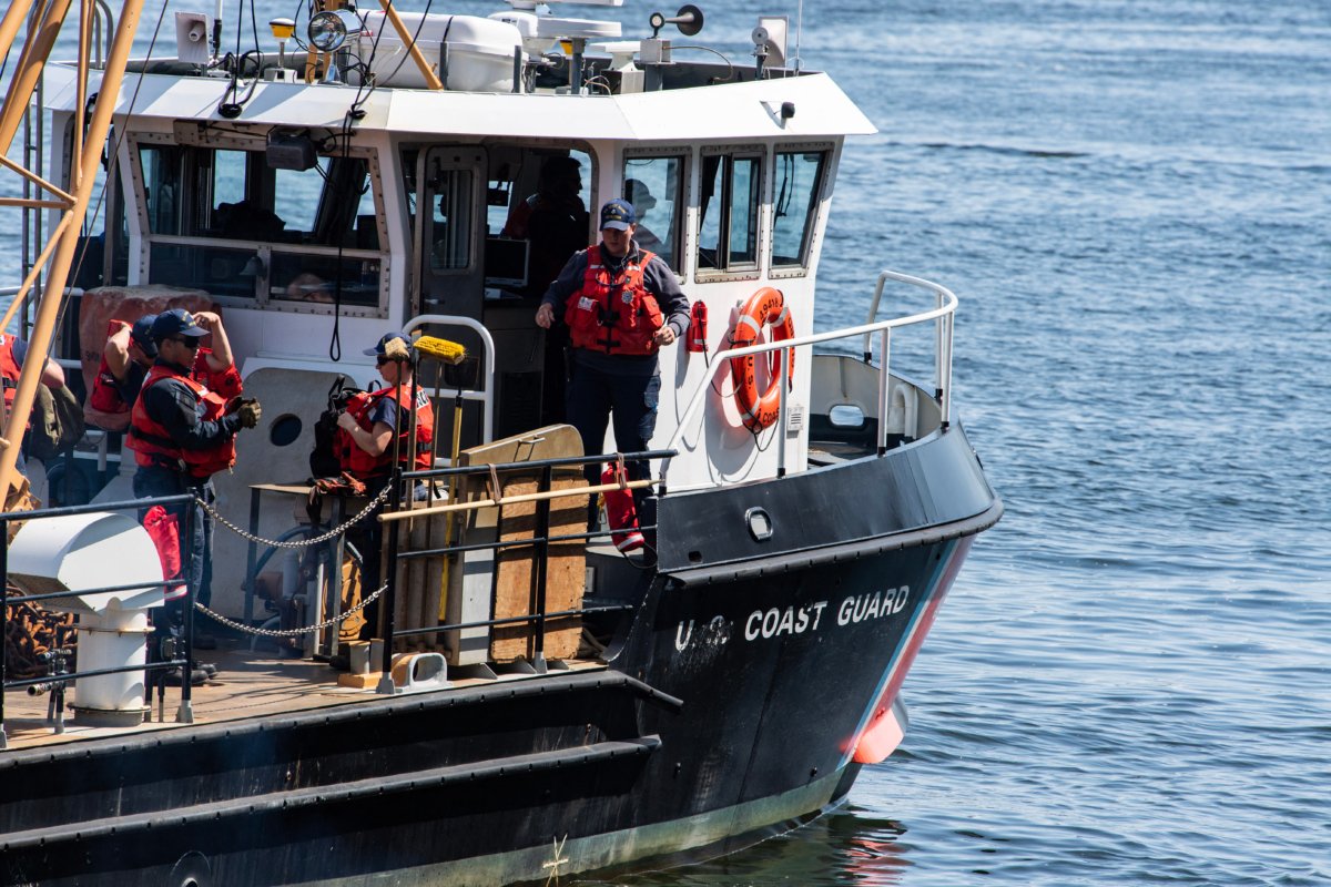 Crews work on Coast Guard vessels at Coast Guard Base Boston in Boston, Mass., on June 21, 2023. (Joseph Prezioso/AFP via Getty Images)