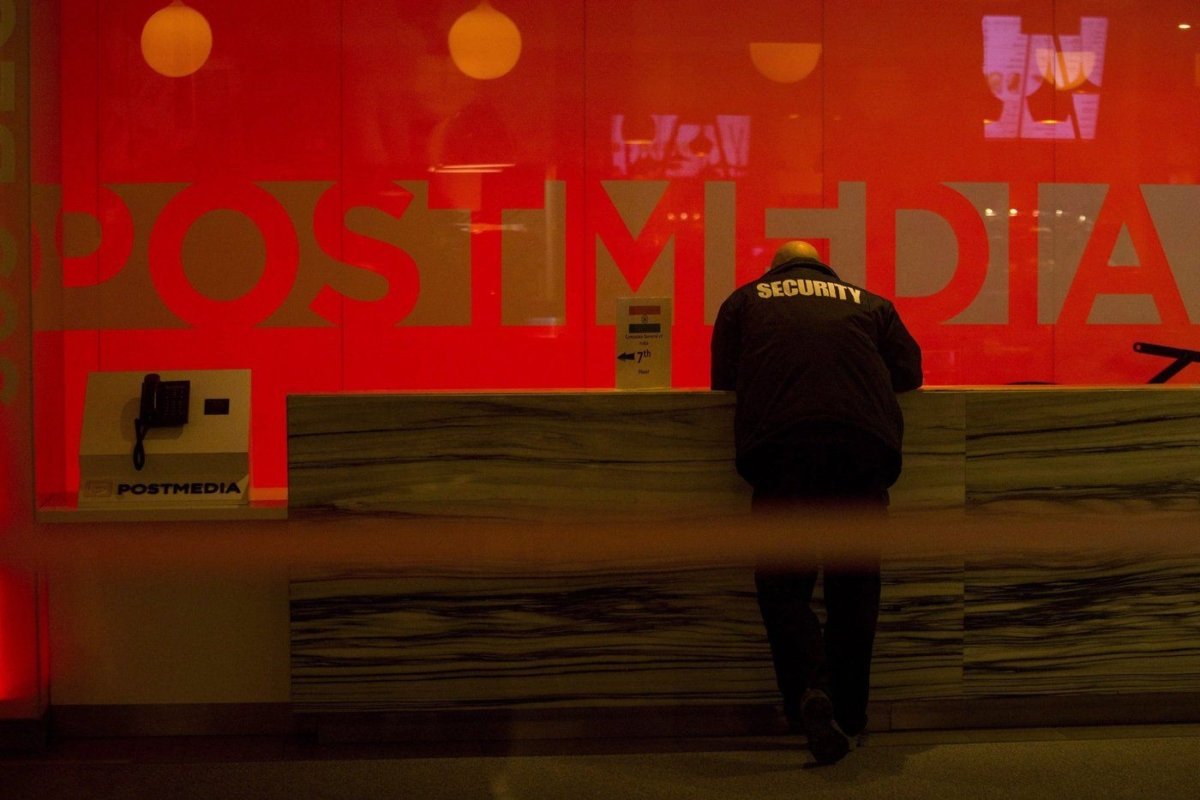 A security guard stands by the front reception desk at Postmedia's Toronto headquarters in a file photo. (The Canadian Press/Chris Young)