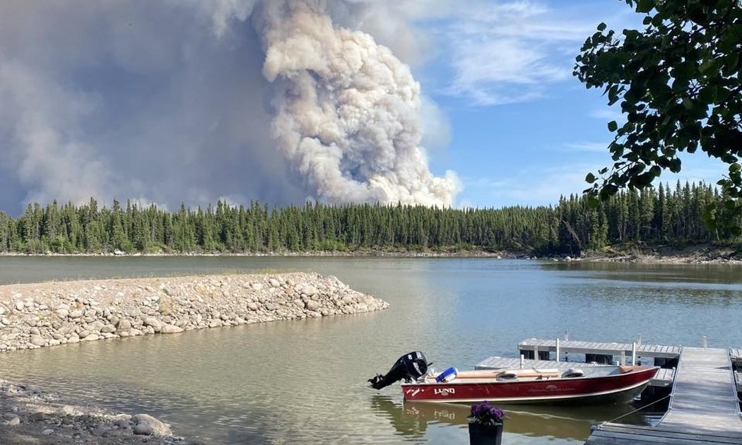 A plume of smoke rises from a wildfire burning near Leaf Rapids, Man., in an undated handout photo. (HO-Dawn Halcrow/The Canadian Press)