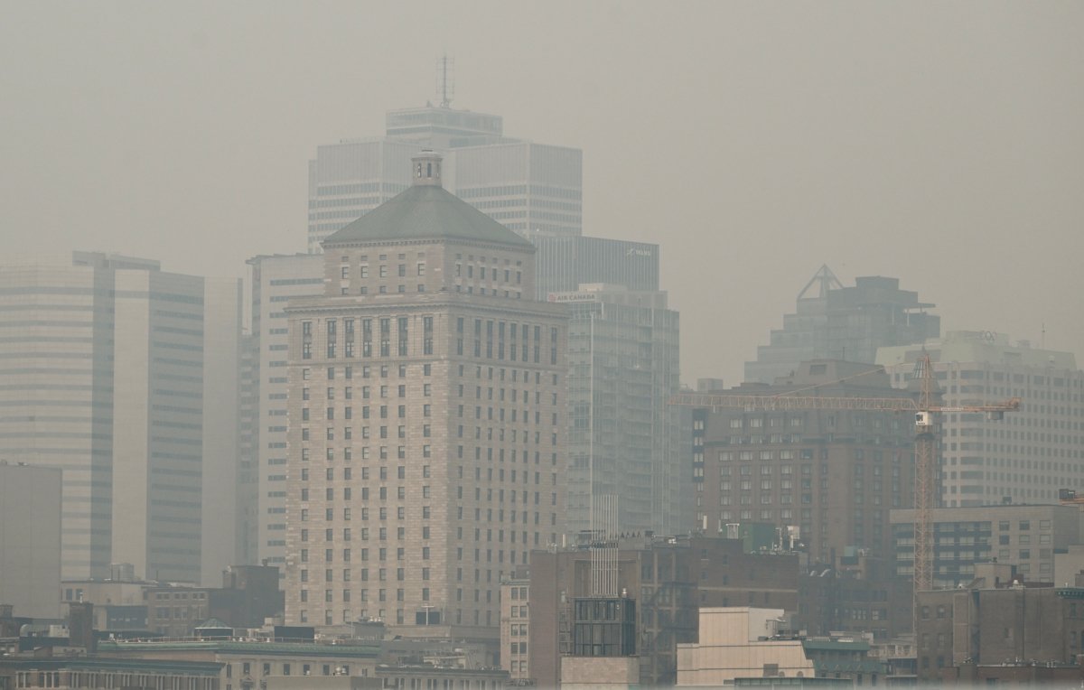 The skyline of Montreal is obscured by a haze of smog on June 25, 2023, as a smog warning is in effect for Montreal and multiple regions of the province due to forest fires. (The Canadian Press/Graham Hughes)