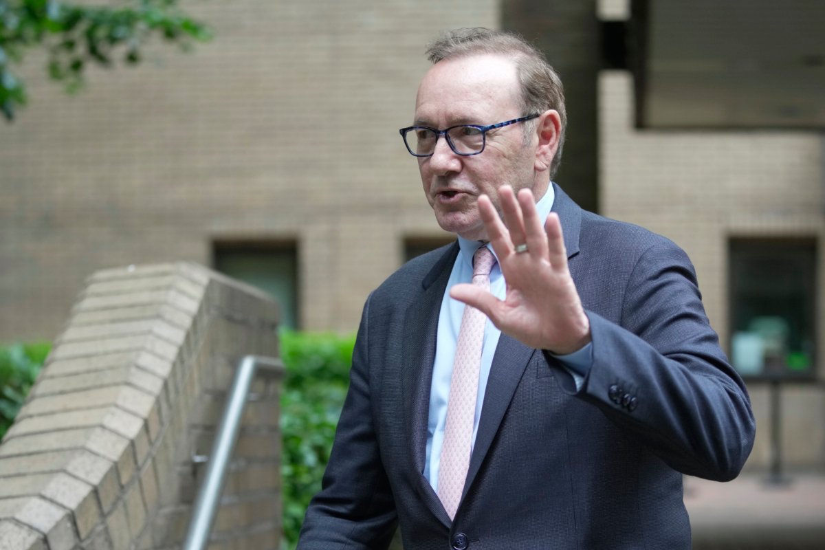 Actor Kevin Spacey waves to the media as he leaves Southwark Crown Court in London on June 28, 2023. (Kin Cheung/AP Photo)