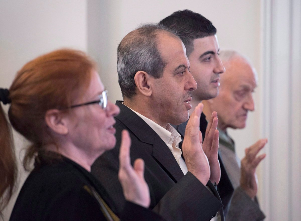 New Canadian citizens take an oath at a ceremony hosted by Immigration, Refugees and Citizenship Canada at Government House in Halifax on Nov. 20, 2017. (Andrew Vaughan/The Canadian Press)