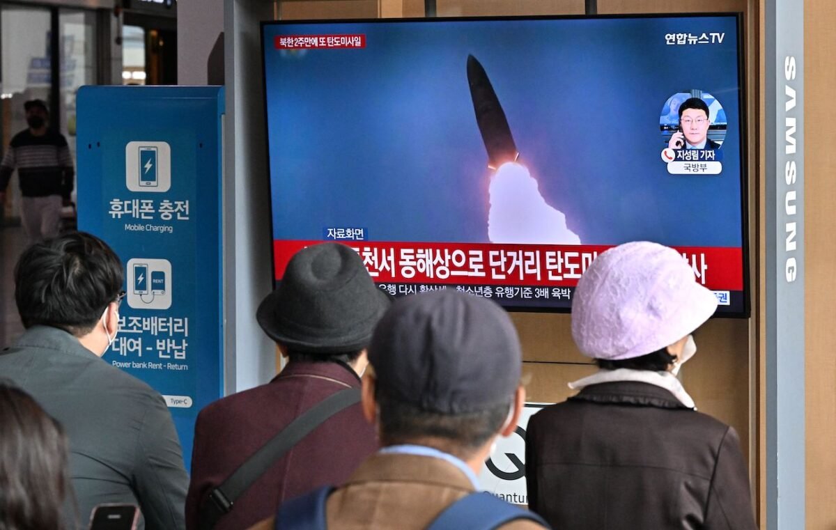 People watch a television screen showing a news broadcast with file footage of a North Korean missile test, at a railway station in Seoul on Oct. 28, 2022. (Jung Yeon-je/AFP via Getty Images)