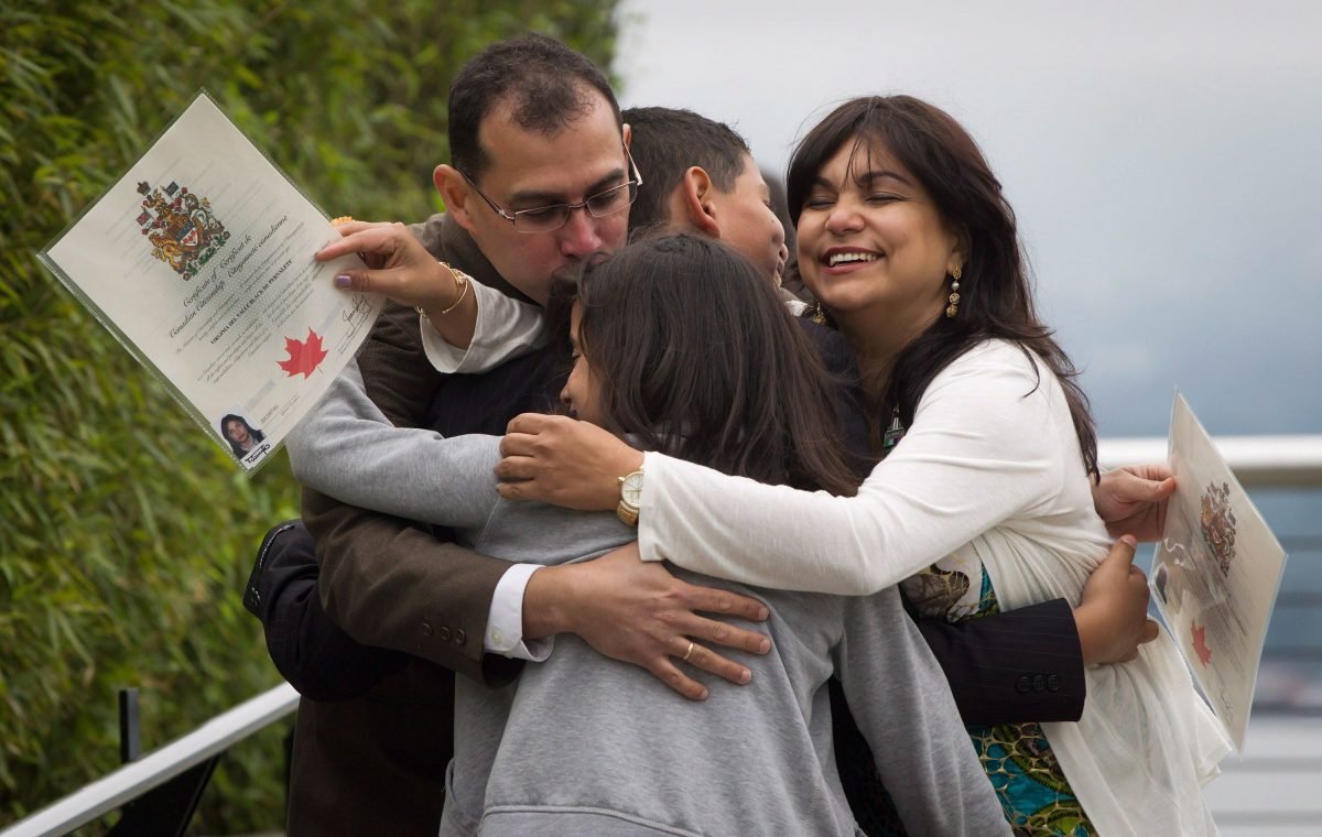 The Pernalete family, originally from Venezuela, engage in a celebratory group hug after being sworn in as Canadian citizens during a special Canada Day citizenship ceremony for 60 people in Vancouver on July 1, 2012. (Darryl Dyck/The Canadian Press)