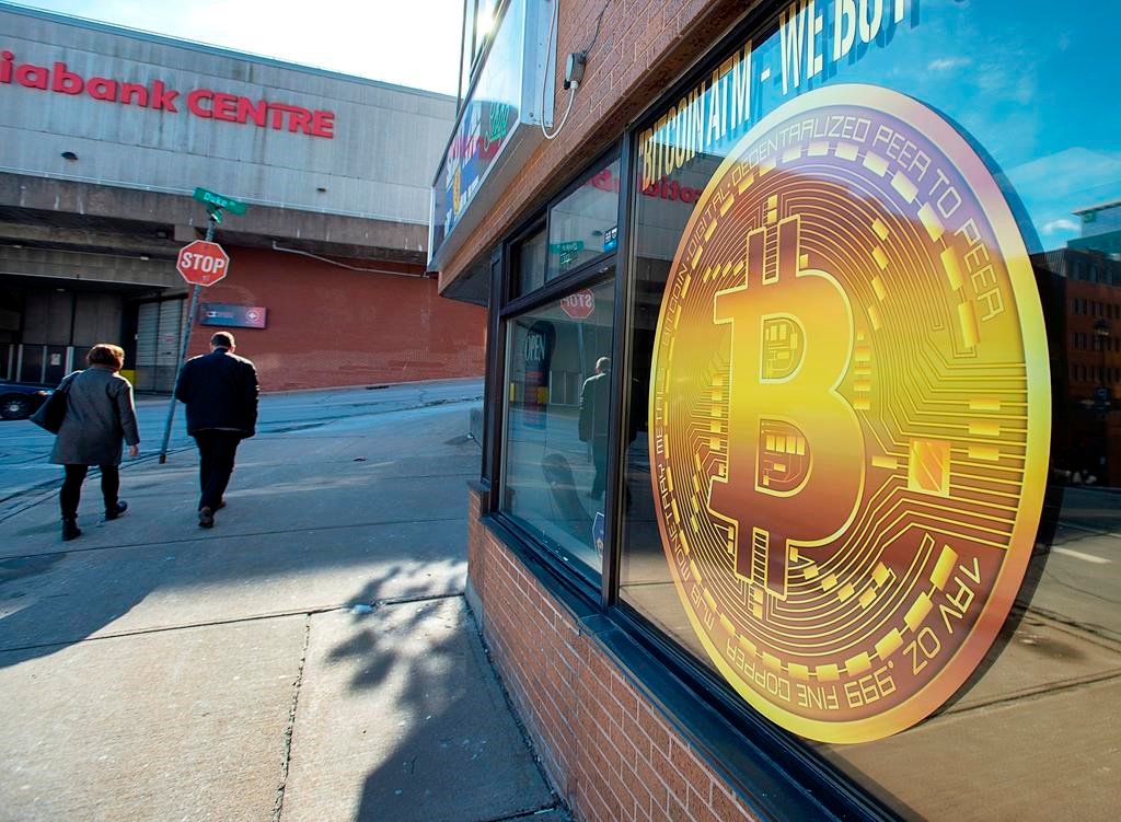 A sign advertises a Bitcoin automated teller machine, ATM, at a shop in Halifax on February 4, 2020.  (Andrew Vaughan / The Canadian Press)