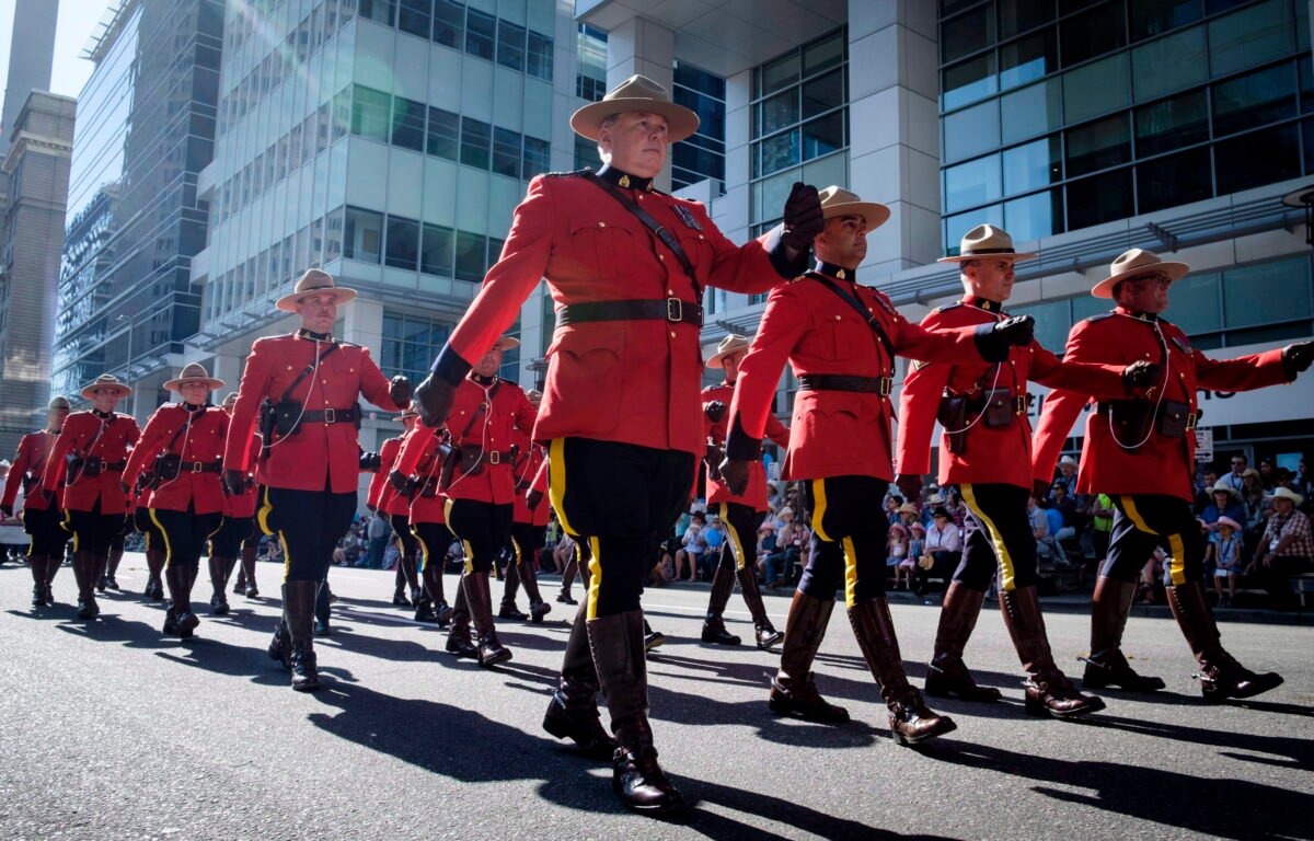 Members of the RCMP march during the Calgary Stampede parade in Calgary, on July 6, 2018. (The Canadian Press/Jeff McIntosh)