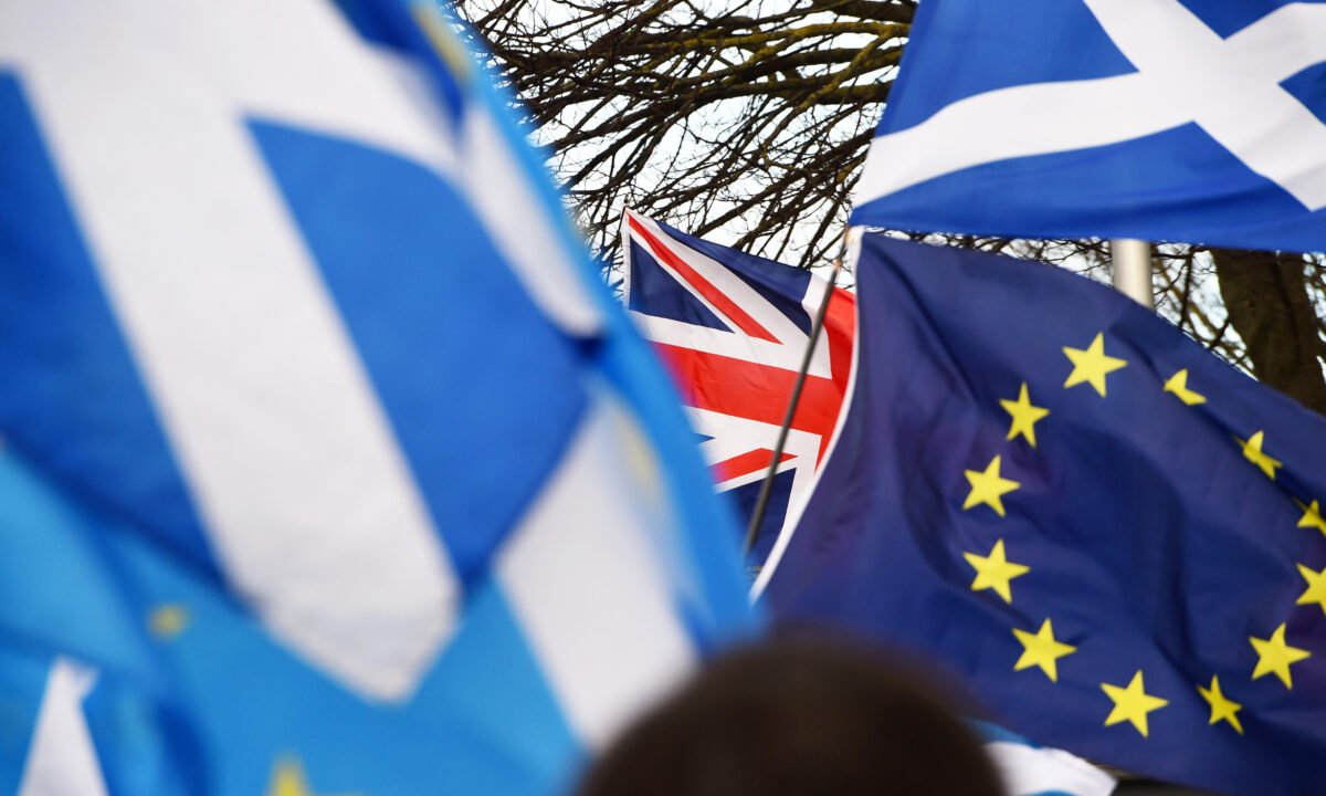 Scottish Saltire and EU flags fly during an anti-Conservative government, pro-Scottish independence, and anti-Brexit demonstration outside Holyrood in Edinburgh on Feb. 1, 2020. (Andy Buchanan/AFP via Getty Images)