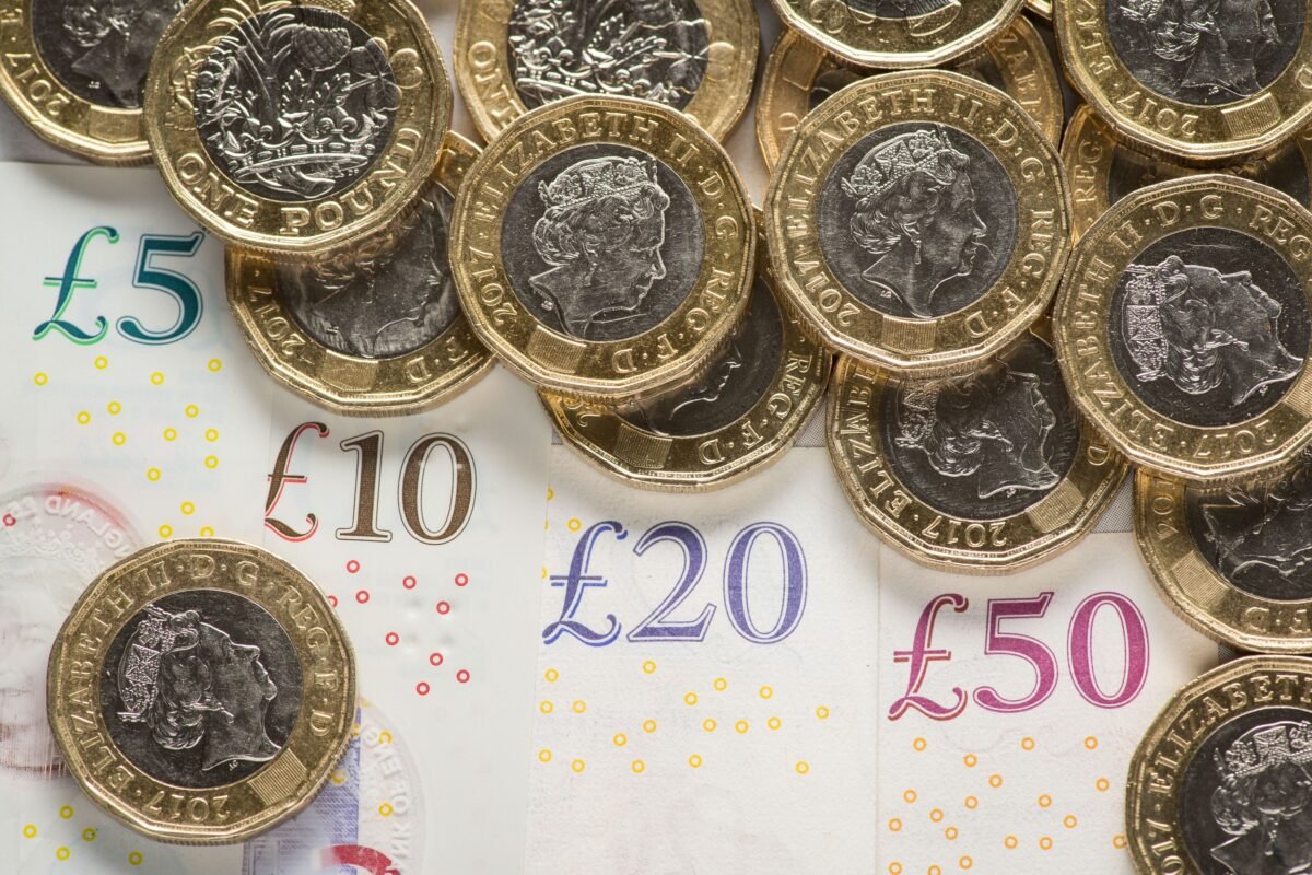UK five pound, ten pound, twenty pound, and fifty pound notes with one pound coins, shown in a file photo dated Jan. 26, 2018. (Dominic Lipinski/PA)