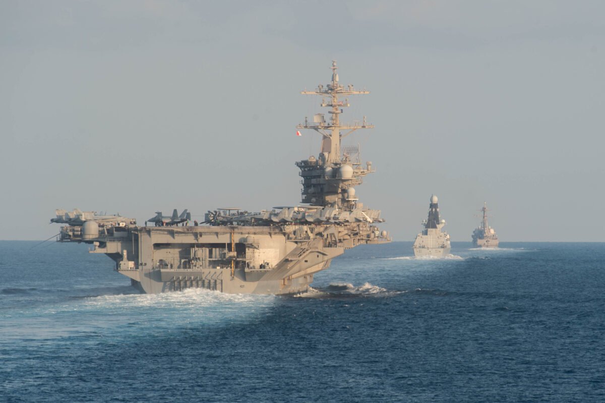 The aircraft carrier USS Abraham Lincoln (CVN 72) (L) the Royal Navy air defense destroyer HMS Defender (D 36) and the guided-missile destroyer USS Farragut (DDG 99) transit the Strait of Hormuz in this handout photo on Nov. 19, 2019. (Zachary Pearson/U.S. Navy via Getty Images)