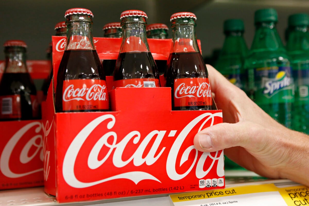 An employee arranges bottles of Coca-Cola at a store in Alexandria, Va., on Oct. 16, 2012. (Kevin Lamarque/Reuters)