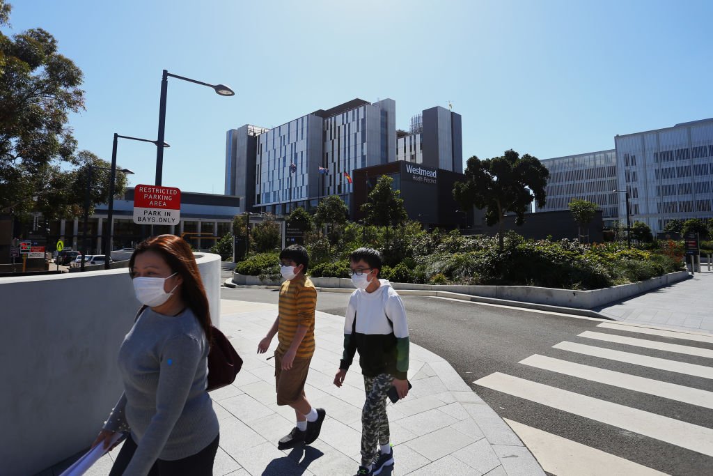 People are seen walking past the main entrance of Westmead Hospital in Sydney, Australia on Sept. 8, 2021. (Lisa Maree Williams/Getty Images)
