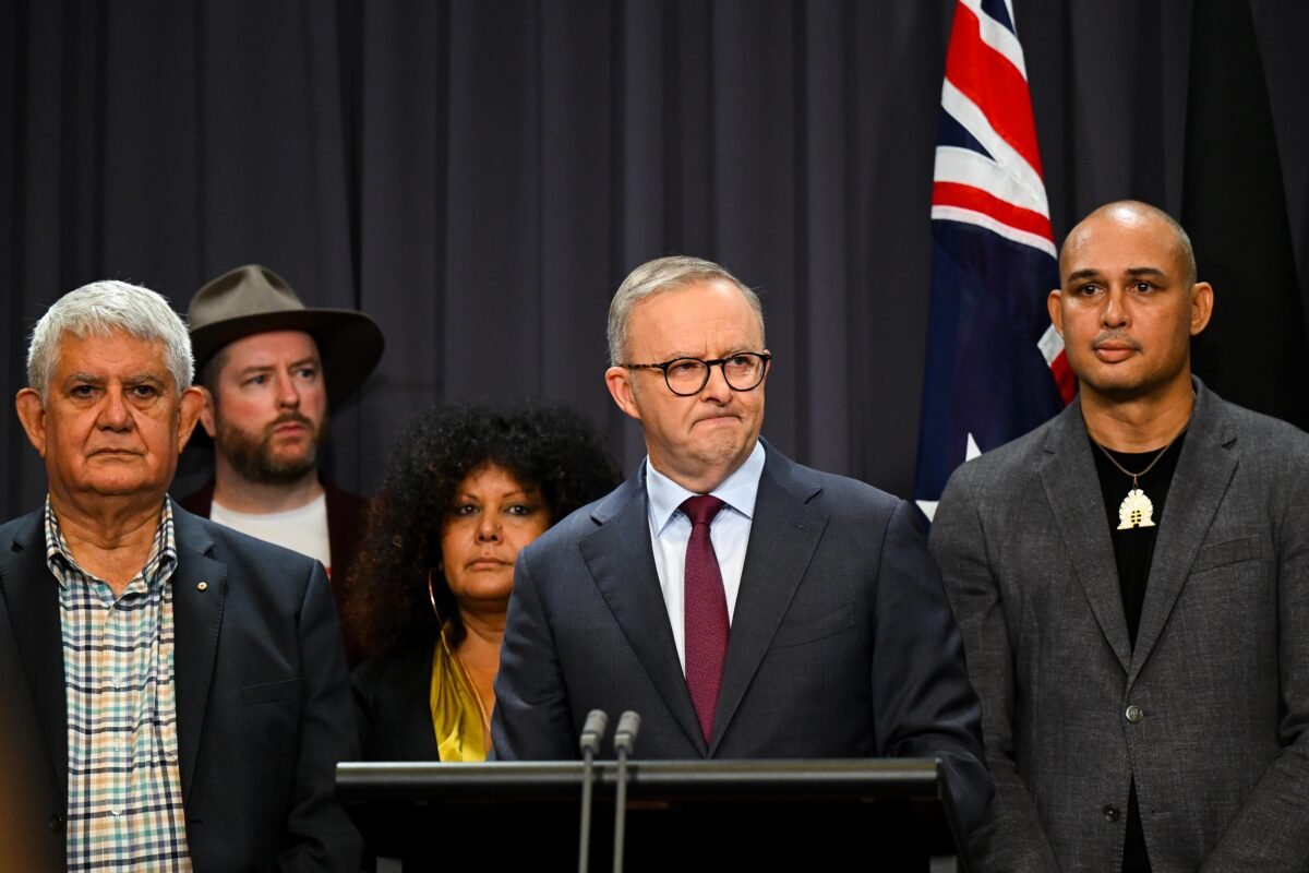 Australian Prime Minister Anthony Albanese surrounded by members of the First Nations Referendum Working Group (Thomas Mayo to his right) speaks to the media during a press conference at Parliament House in Canberra, Australia on March 23, 2023. (AAP Image/Lukas Coch)