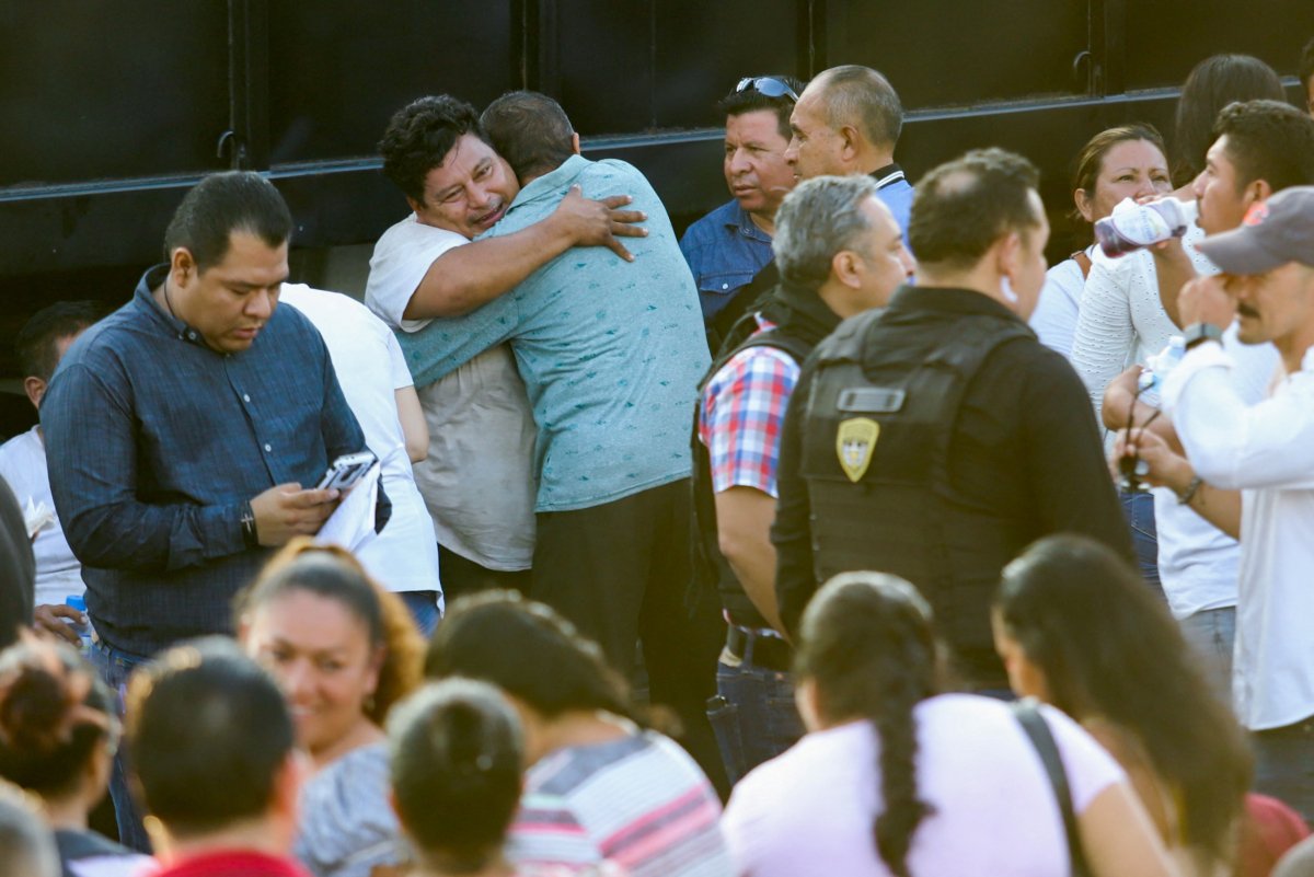 State security ministry employees, who were kidnapped by members of an armed group days ago, react after meeting their relatives after being freed, outside the Secretary of Public Security and Citizen Protection of Chiapas, in Tuxtla Gutierrez building, Mexico, on June 30, 2023. (Jacob Garcia/Reuters)