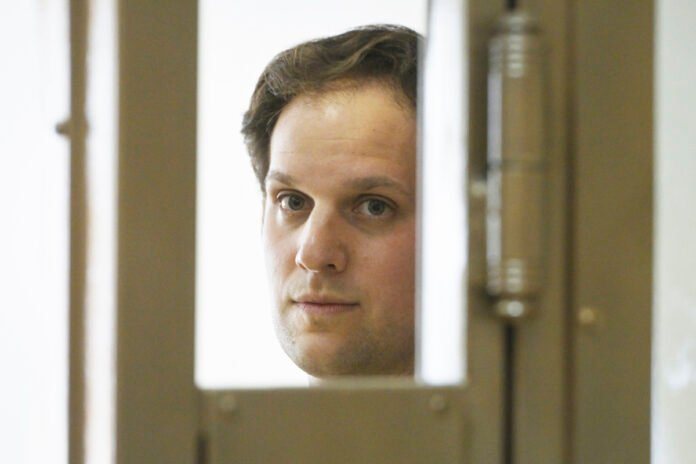 Wall Street Journal reporter Evan Gershkovich stands in a glass cage in a courtroom at the Moscow City Court in Moscow on June 22, 2023. (Dmitry Serebryakov/AP Photo)