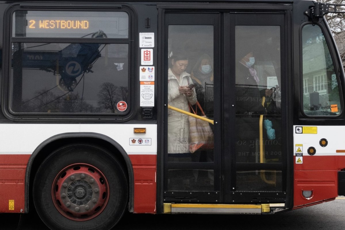 People ride on a shuttle bus outside a west-end Toronto subway stop after subway service was closed during the morning commute on April 5, 2023. (The Canadian Press/Graeme Roy)
