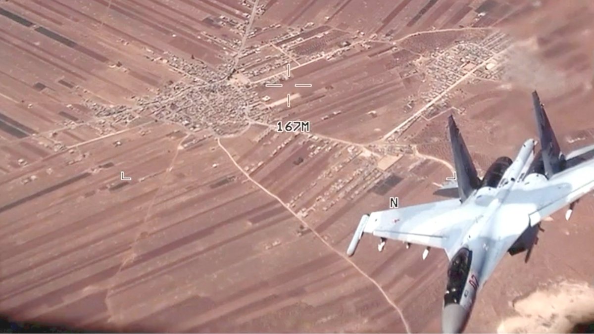 In this image from video released by the U.S. Air Force, a Russian SU-35 flies near a U.S. Air Force MQ-9 Reaper drone over Syria on July 5, 2023. (U.S. Air Force via AP)