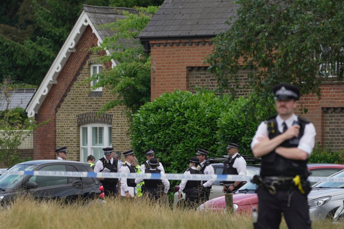 Police officers set up cordon line as a car crashed into a primary school building in Wimbledon, London, on July 6, 2023. (Kin Cheung/AP Photo)