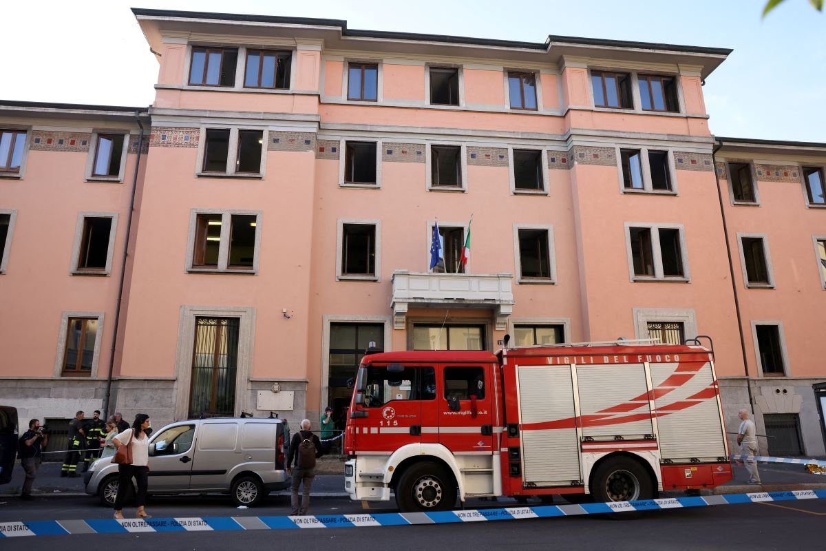 Firefighters work at the scene following a fire in a retirement home in Milan, Italy, on July 7, 2023. (Claudia Greco/Reuters)