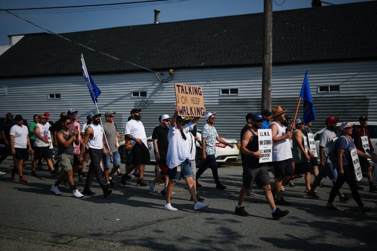 Striking International Longshore and Warehouse Union Canada workers march from the port to a rally, in Vancouver, on July 6, 2023. (The Canadian Press/Darryl Dyck)