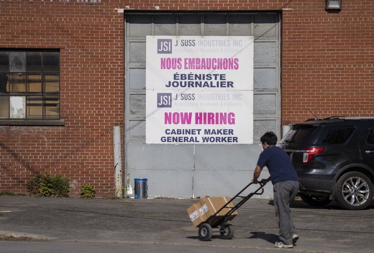 A "Now Hiring" sign is displayed on a business in Montreal on May 30, 2023. (The Canadian Press/Christinne Muschi)