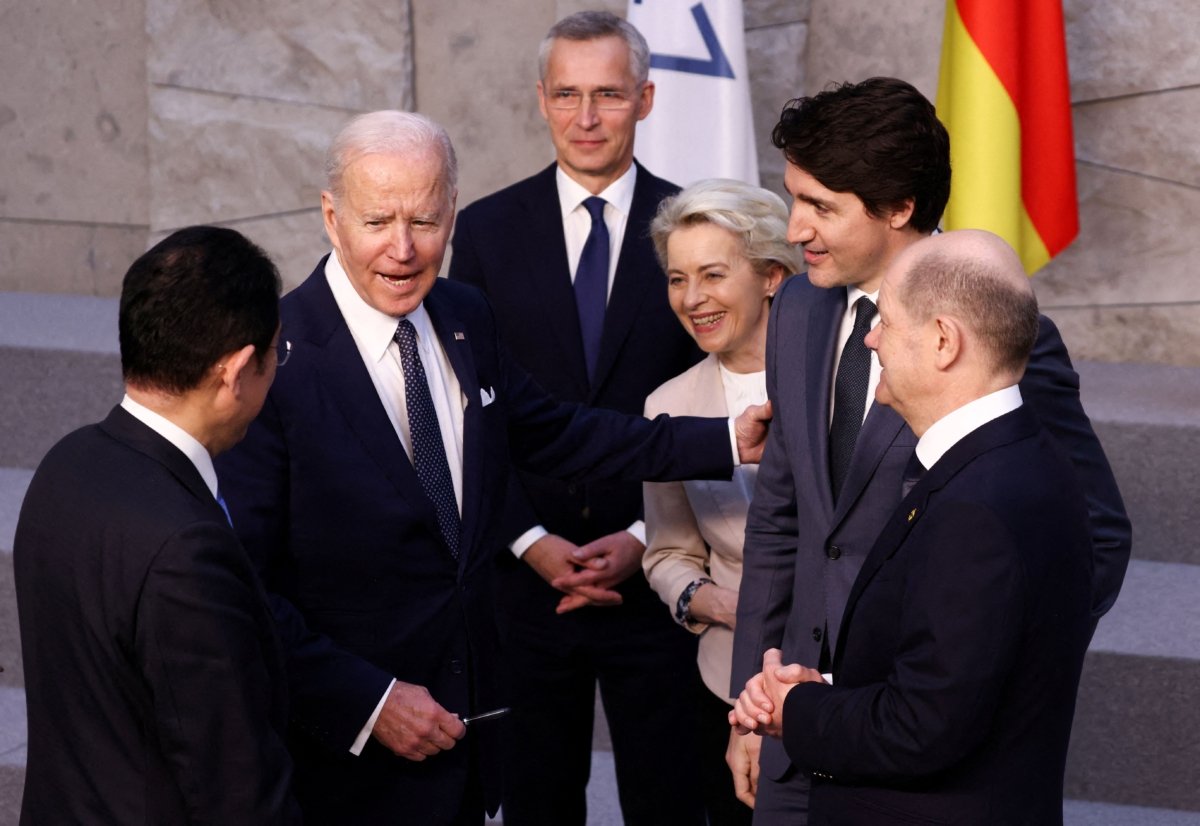 Japan's Prime Minister Fumio Kishida (L) U.S. President Joe Biden (2L) and Germany's Chancellor Olaf Scholz (R) speak next to NATO Secretary General Jens Stoltenberg (C), European Commission President Ursula von der Leyen (3R) and Canada's Prime Minister Justin Trudeau (2R) before a G7 leaders' family photograph during a NATO summit at the alliance's headquarters in Brussels on March 24, 2022. (Henry Nicholls/Pool/AFP via Getty Images)