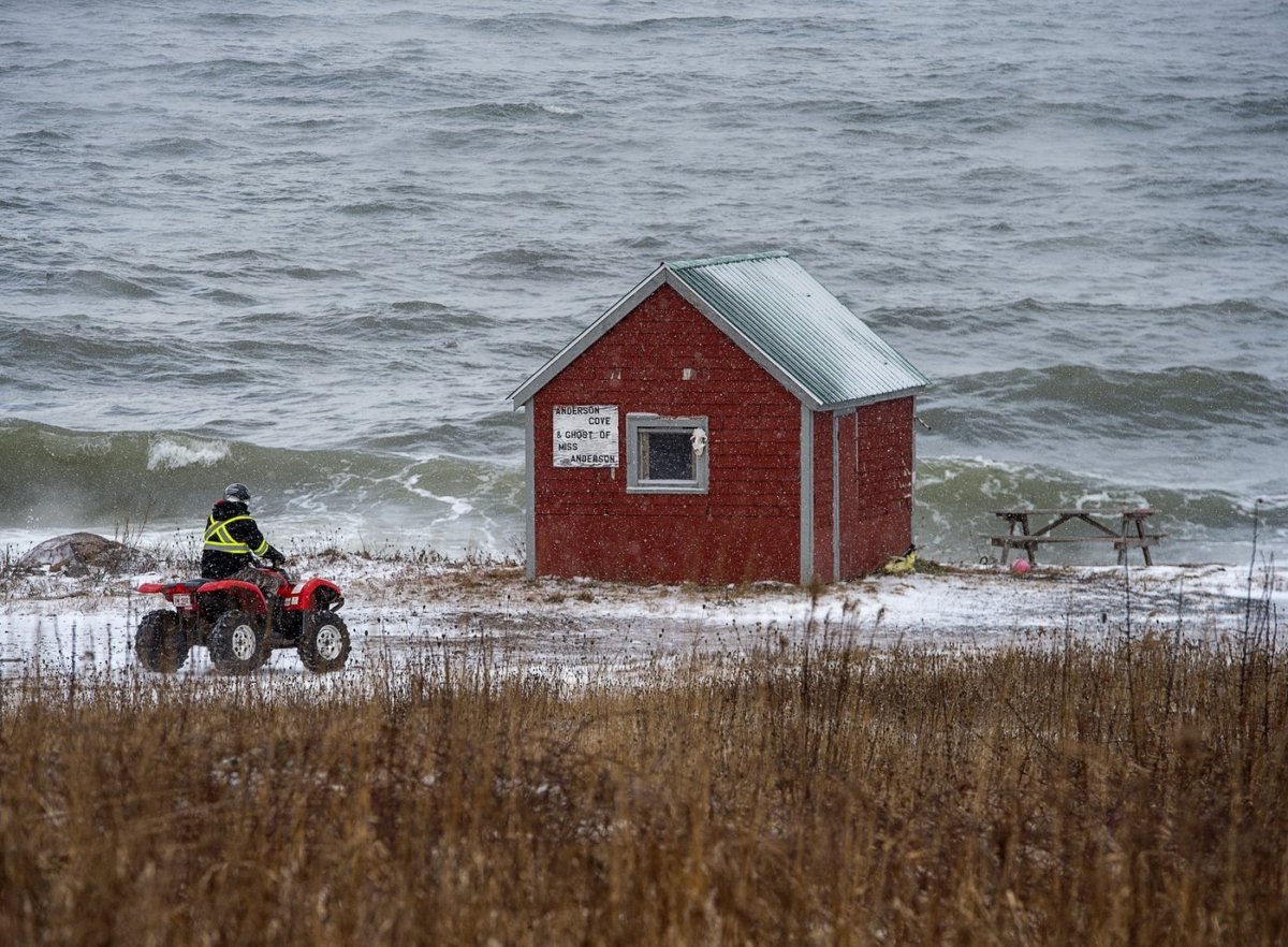 A searcher rides along the shore of the Bay of Fundy in Hillsburn, N.S., as they continue to look for missing fishermen after the sinking of the scallop dragger Chief William Saulis, on Dec. 16, 2020. (The Canadian Press/Andrew Vaughan)
