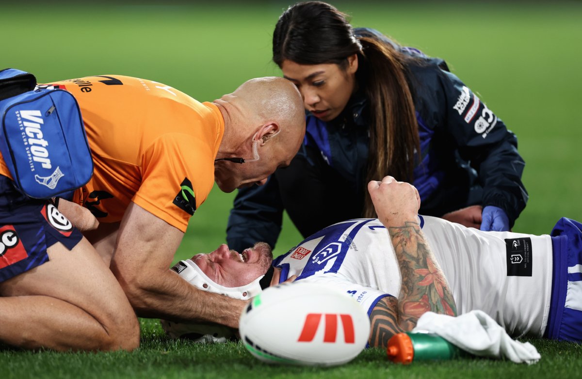 Ryan Sutton of the Bulldogs receives attention after injuring himself in a tackle during the round 19 NRL match between South Sydney Rabbitohs and Canterbury Bulldogs at Accor Stadium in Sydney, Australia, on July 8, 2023. (Cameron Spencer/Getty Images)
