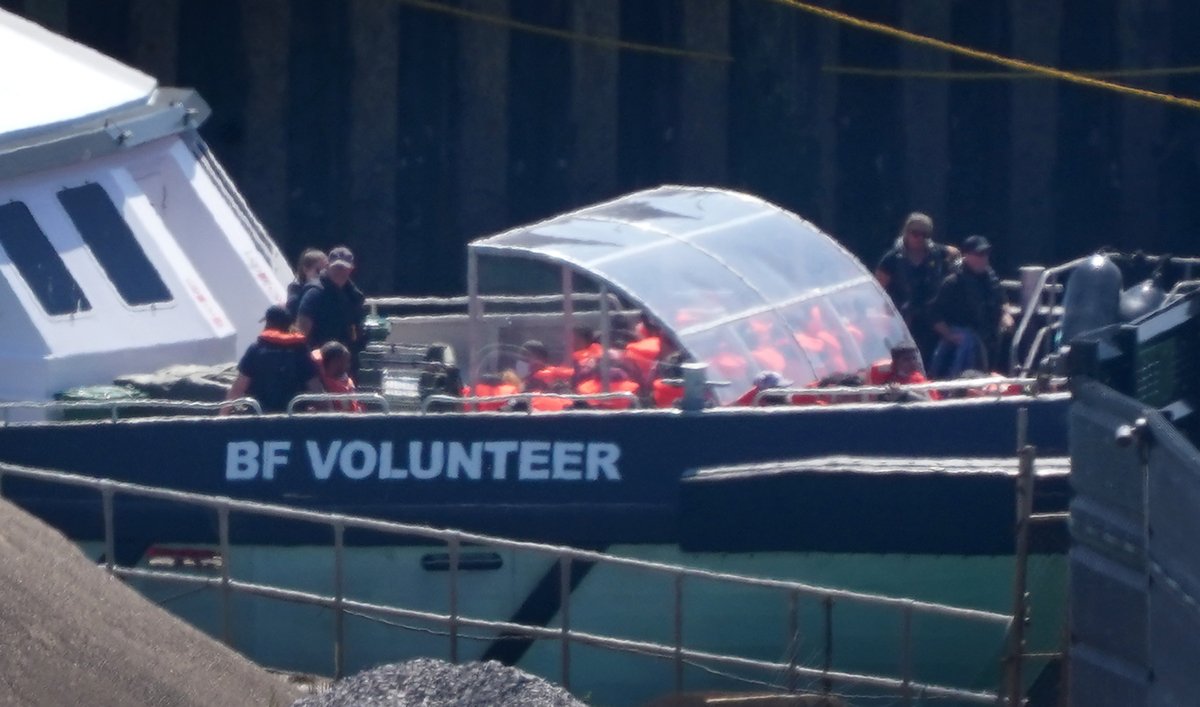 A group of people thought to be illegal immigrants are brought in onboard a Border Force vessel to Dover, Kent, on July 7, 2023. (Gareth Fuller/PA Media)